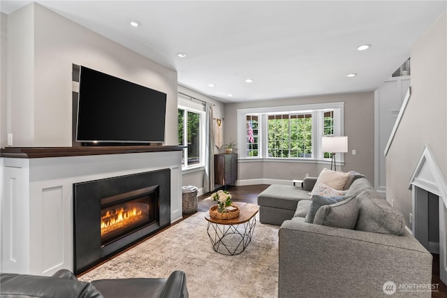 856 Hilltop Ave, Kent, WA 98031 - living area with a glass covered fireplace, recessed lighting, wood finished floors, and baseboards