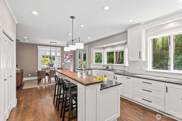 856 Hilltop Ave, Kent, WA 98031 - kitchen with a sink, white cabinets, butcher block countertops, a breakfast bar area, and recessed lighting