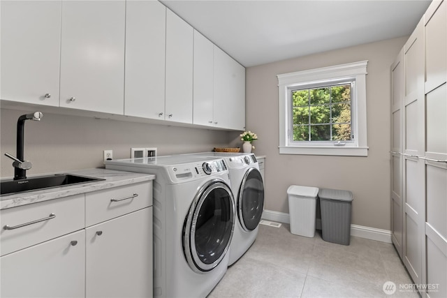 856 Hilltop Ave, Kent, WA 98031 - clothes washing area with cabinet space, washing machine and dryer, baseboards, and light tile patterned floors