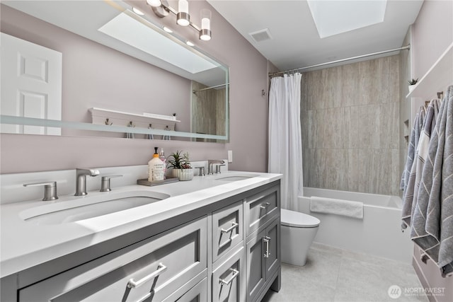 856 Hilltop Ave, Kent, WA 98031 - bathroom featuring toilet, double vanity, tile patterned flooring, shower / bath combo, and a skylight