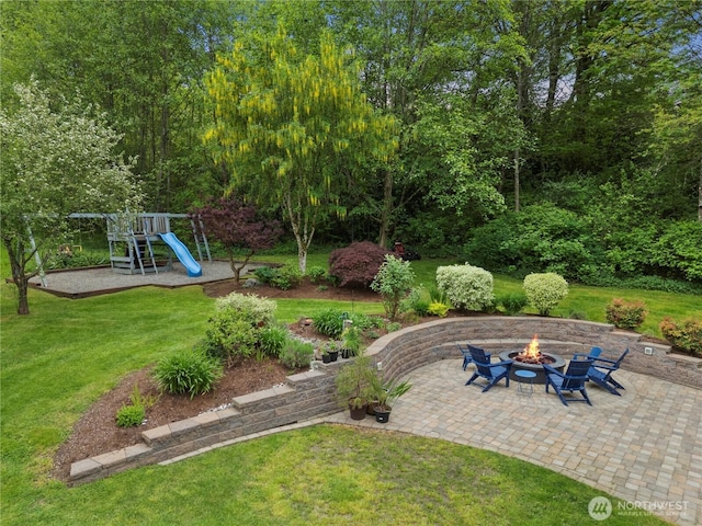 856 Hilltop Ave, Kent, WA 98031 - view of green lawn featuring a fire pit, a playground, and a patio area