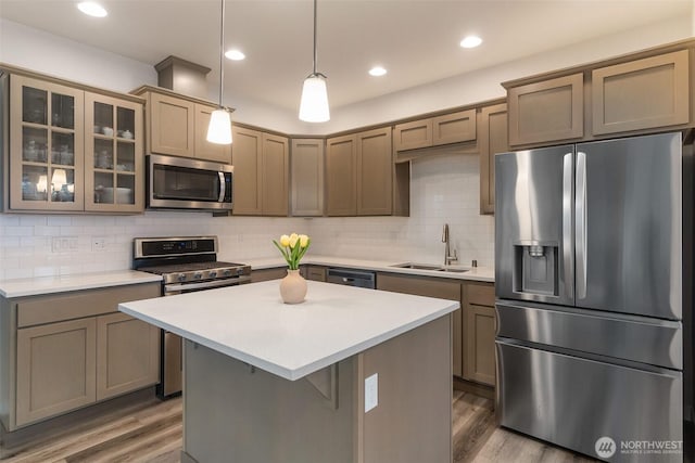 3215 64th Ln SW, Olympia, WA 98512 - kitchen featuring light countertops, appliances with stainless steel finishes, a sink, and wood finished floors