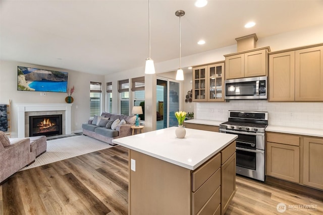 3215 64th Ln SW, Olympia, WA 98512 - kitchen featuring light countertops, open floor plan, appliances with stainless steel finishes, and a center island