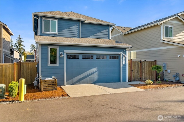 3215 64th Ln SW, Olympia, WA 98512 - traditional home with concrete driveway, a shingled roof, an attached garage, and fence