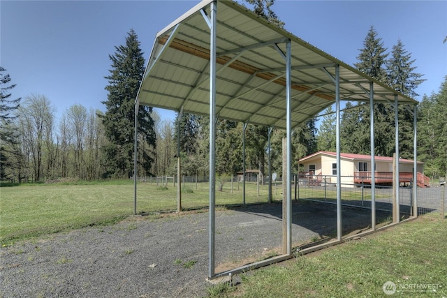 view of car parking with a detached carport and driveway