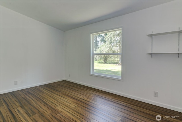 unfurnished room featuring dark wood finished floors and baseboards