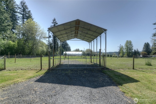 view of vehicle parking featuring driveway and a carport