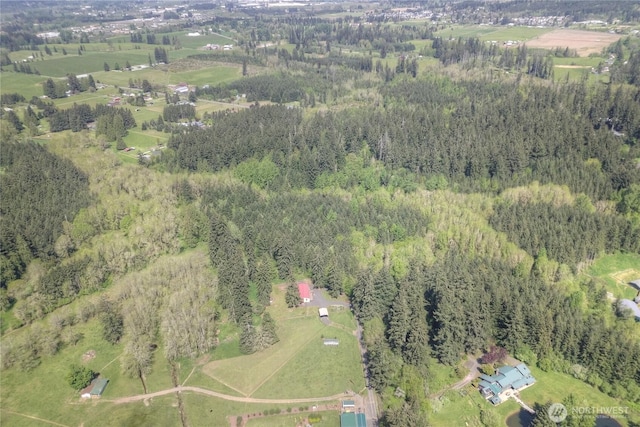 aerial overview of property's location featuring a heavily wooded area