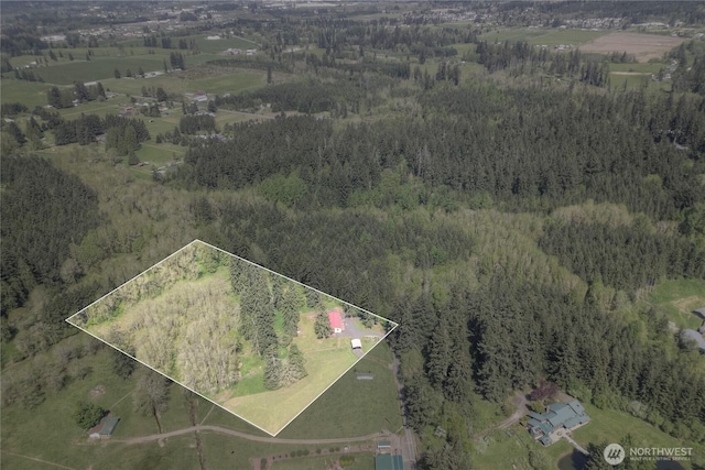 view of property location featuring a heavily wooded area and property boundaries highlighted