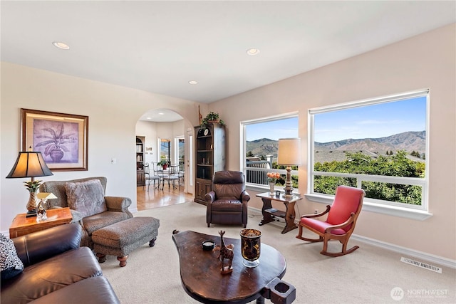 1552 Huntwood Ln, East Wenatchee, WA 98802 - living area with arched walkways, a mountain view, carpet, recessed lighting, and baseboards