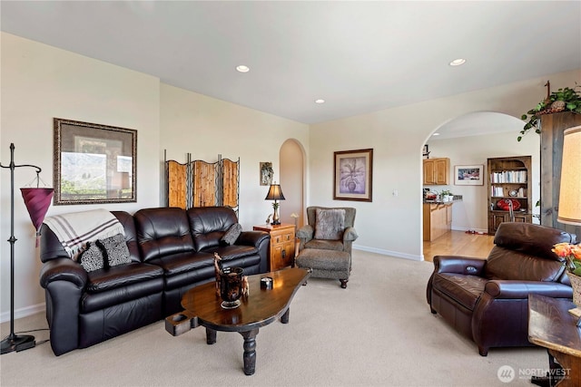 1552 Huntwood Ln, East Wenatchee, WA 98802 - living room with arched walkways, light colored carpet, baseboards, and recessed lighting