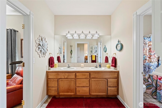 1552 Huntwood Ln, East Wenatchee, WA 98802 - ensuite bathroom featuring double vanity, toilet, and baseboards