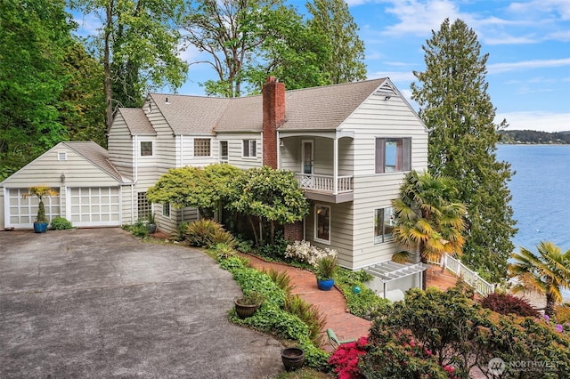 11709 SW 252nd Ln, Vashon, WA 98070 - view of front facade featuring a balcony, a shingled roof, a garage, a chimney, and an outbuilding