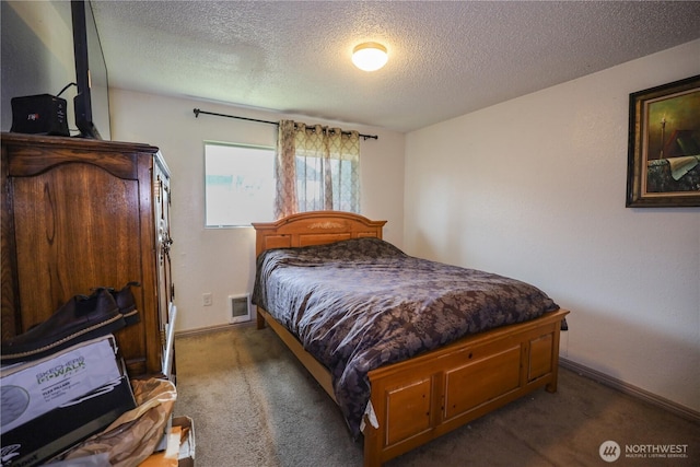bedroom featuring a textured ceiling, carpet flooring, and baseboards