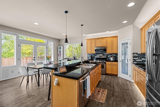 4002 33rd St NE, Tacoma, WA 98422 - kitchen with appliances with stainless steel finishes, a sink, dark wood finished floors, backsplash, and an island with sink
