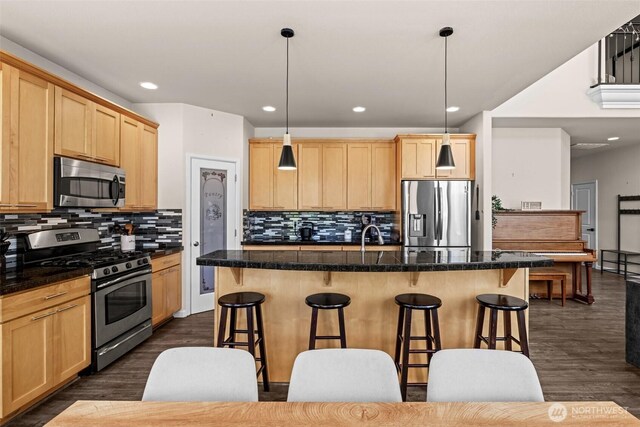 4002 33rd St NE, Tacoma, WA 98422 - kitchen featuring appliances with stainless steel finishes, light brown cabinetry, a breakfast bar area, dark wood finished floors, and recessed lighting