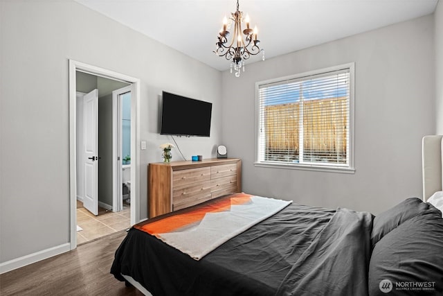 4002 33rd St NE, Tacoma, WA 98422 - bedroom featuring a chandelier, wood finished floors, and baseboards