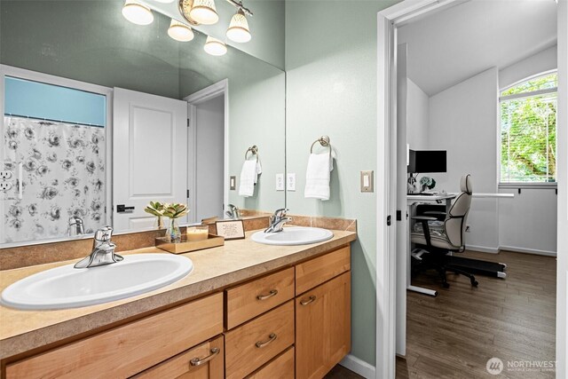 4002 33rd St NE, Tacoma, WA 98422 - bathroom with double vanity, wood finished floors, lofted ceiling, and baseboards