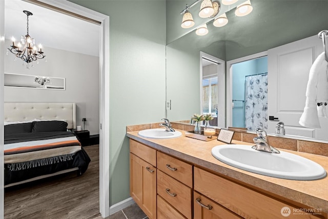 4002 33rd St NE, Tacoma, WA 98422 - full bath featuring a chandelier, connected bathroom, double vanity, and baseboards