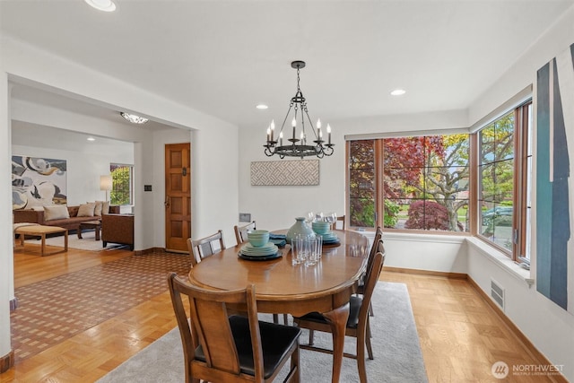 dining room with a chandelier, healthy amount of natural light, baseboards, and recessed lighting