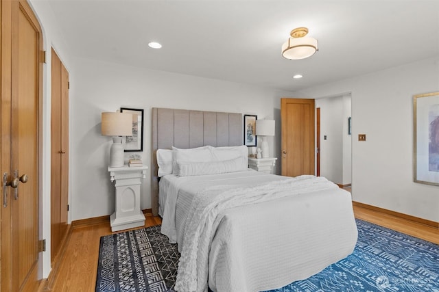 bedroom featuring light wood finished floors, baseboards, and recessed lighting