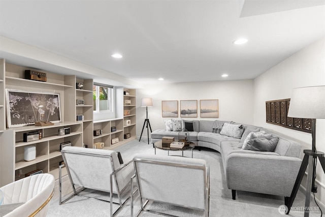 carpeted living area with recessed lighting and built in features