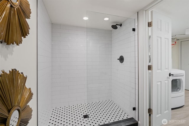 full bathroom with a stall shower, washer / dryer, and recessed lighting
