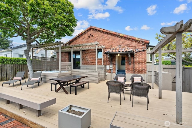deck featuring a pergola, a fenced backyard, and an outdoor hot tub