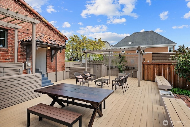 wooden terrace with a pergola, fence, and an outdoor living space