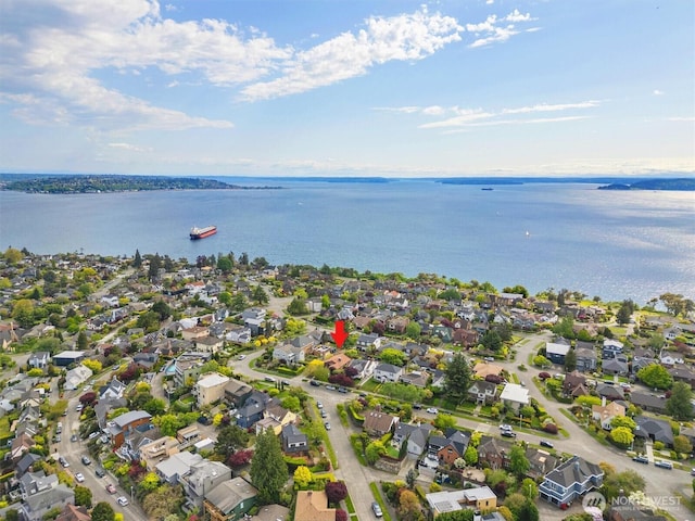 aerial view of residential area featuring a large body of water