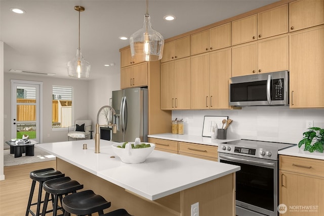 10604 NE 137th Pl, Kirkland, WA 98034 - kitchen with appliances with stainless steel finishes, a kitchen breakfast bar, light brown cabinets, backsplash, and recessed lighting