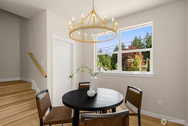 10604 NE 137th Pl, Kirkland, WA 98034 - dining area with a chandelier, baseboards, wood finished floors, and stairs
