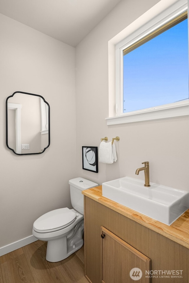 10604 NE 137th Pl, Kirkland, WA 98034 - bathroom featuring baseboards, toilet, wood finished floors, and vanity