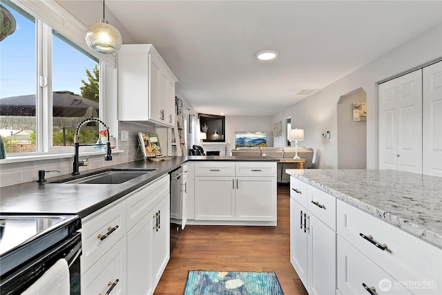 17915 69th Avenue Ct E, Puyallup, WA 98375 - kitchen featuring a sink, decorative backsplash, dark wood finished floors, white cabinetry, and open floor plan