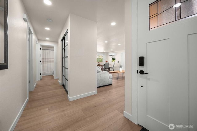 corridor with recessed lighting, baseboards, and light wood-type flooring