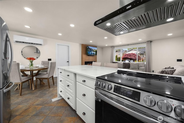 kitchen featuring stainless steel appliances, a wall unit AC, under cabinet range hood, recessed lighting, and white cabinetry