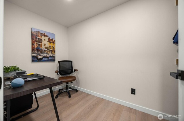 home office with baseboards and wood finished floors