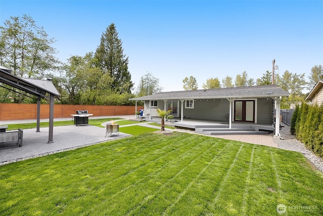 rear view of house featuring a patio area and a wooden deck