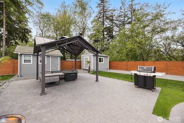 view of patio / terrace featuring a shed, an outdoor structure, grilling area, and an outdoor living space