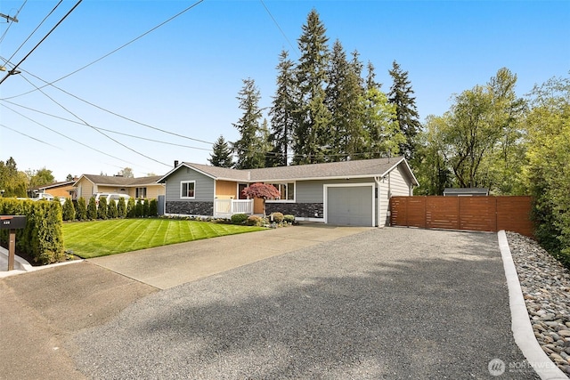 ranch-style home featuring driveway, an attached garage, and stone siding