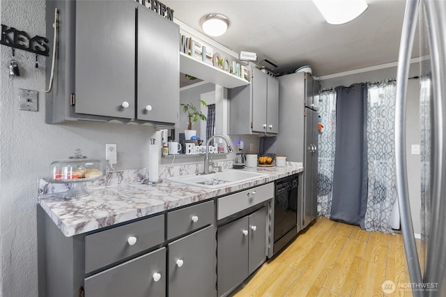 322 W 8th St, Warden, WA 98857 - kitchen with a sink, gray cabinetry, black dishwasher, light wood-style flooring, and light countertops