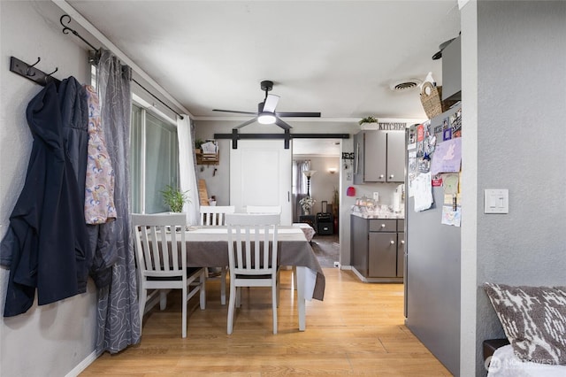 322 W 8th St, Warden, WA 98857 - dining area featuring light wood-style floors, ceiling fan, and a barn door