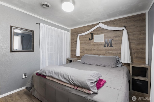 322 W 8th St, Warden, WA 98857 - bedroom featuring wood finished floors, a textured wall, baseboards, and wooden walls