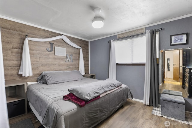 322 W 8th St, Warden, WA 98857 - bedroom with wood finished floors, wood walls, and baseboards