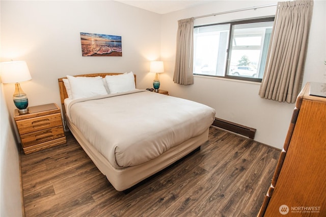 bedroom with dark wood finished floors
