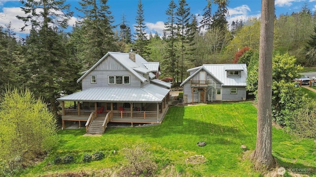 1005 Cavalero Rd, Camano Island, WA 98282 - rear view of house with a yard, a chimney, metal roof, a porch, and stairway