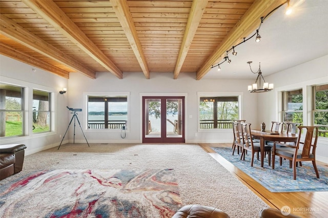 1005 Cavalero Rd, Camano Island, WA 98282 - dining space with baseboards, wood ceiling, rail lighting, a chandelier, and beamed ceiling