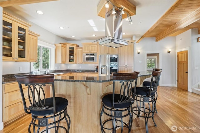 1005 Cavalero Rd, Camano Island, WA 98282 - kitchen featuring light wood-type flooring, stainless steel fridge, a kitchen breakfast bar, and light brown cabinets