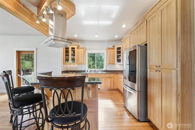1005 Cavalero Rd, Camano Island, WA 98282 - kitchen featuring light brown cabinetry, light wood finished floors, island range hood, dark countertops, and stainless steel appliances