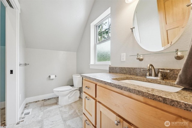 1005 Cavalero Rd, Camano Island, WA 98282 - bathroom featuring toilet, baseboards, visible vents, vanity, and vaulted ceiling